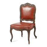 A Louis XV period walnut side chair, with a later leather padded back and seat, the frame finely