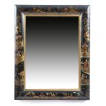 A black japanned wall mirror in early 18th century style, the rectangular bevelled plate within a
