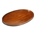 A George III mahogany oval tray, inlaid with boxwood stringing, the centre with an oval kingwood
