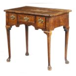A George II walnut lowboy, the quarter veneered top with cross and feather banding and with a