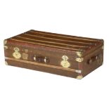 A canvas and leather trunk in Louis Vuitton style, brass studded and with gilt metal mounts, with