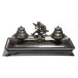 A late 19th century French bronze and black marble Grand Tour inkstand, with Bacchus pouring wine,