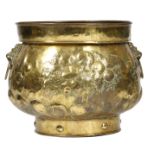A late 19th century Dutch brass logbin or jardiniere, the body repousse decorated with fruits and