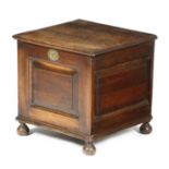 An early 18th century oak closed stool, the hinged top with a moulded edge above a vacant interior