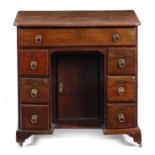 A George II mahogany kneehole desk, the top with a caddy moulded edge, with re-entrant front