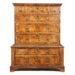 A George II walnut chest on chest, with three short and five long cross and feather banded