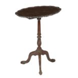 A mahogany tripod table in George II style, the oval tilt-top with a pie crust moulded edge, on a