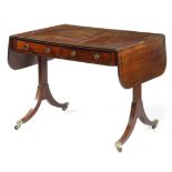 A Regency mahogany sofa table, inlaid with ebonised stringing, the drop-leaf top above a pair of