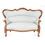 A Victorian mahogany two seater sofa, with a moulded showframe and a serpentine wing back, on