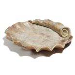 An Italian alabaster holy water stoup, in the form of a shell, 18th / 19th century, 31.2cm wide.