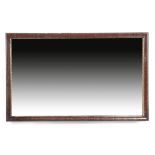 A George II red walnut wall mirror, the rectangular plate within a carved gilt slip and a moulded