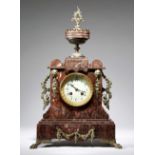 A late 19th century French rouge griotte marble mantel clock, the eight day brass cased drum