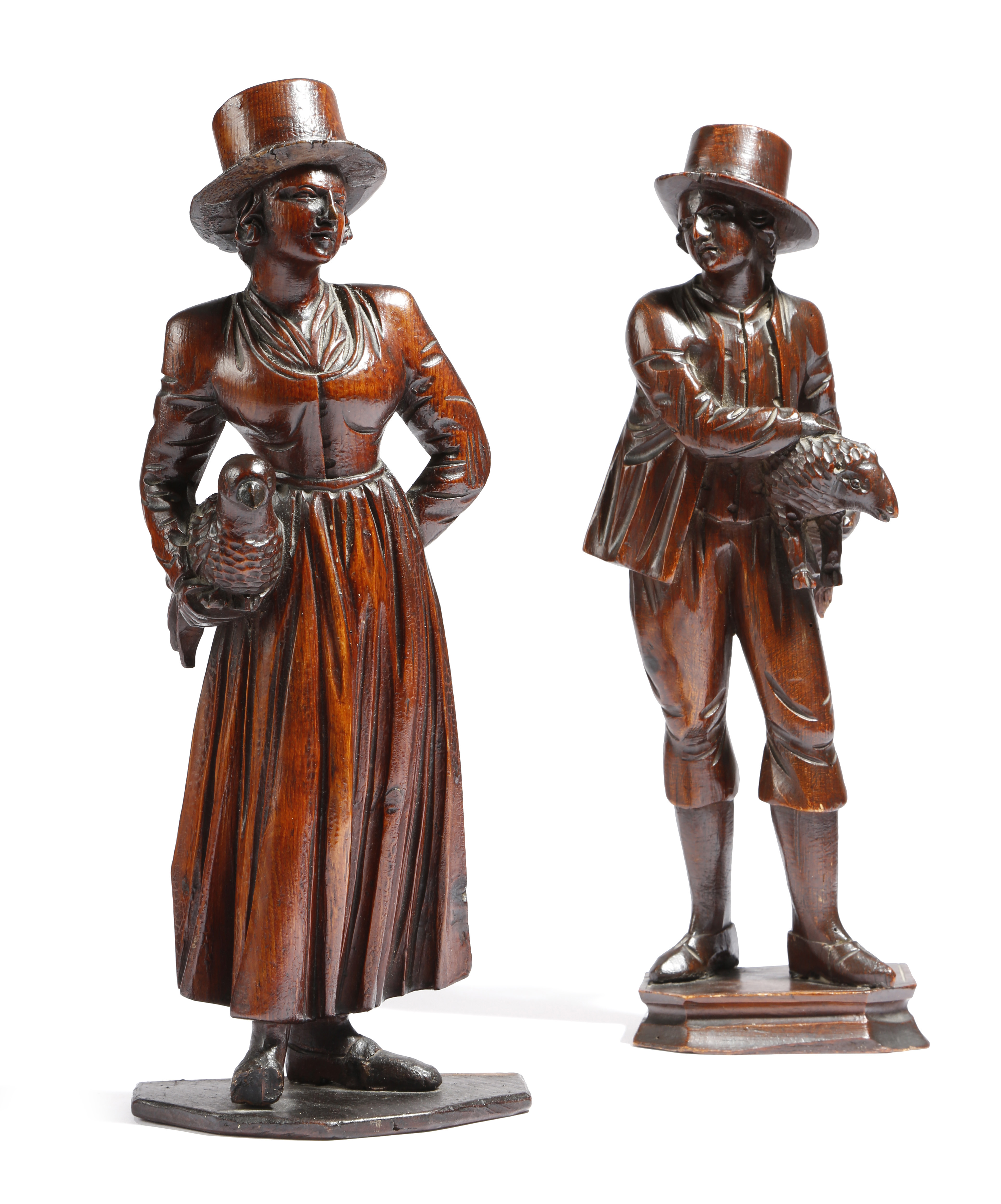 Two 19th century carved and stained wood figures of country folk, one of a shepherd holding a