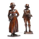 Two 19th century carved and stained wood figures of country folk, one of a shepherd holding a
