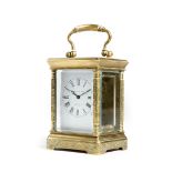 A French gilt brass miniature carriage clock, with a platform lever escapement, the enamel dial with