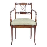 A mahogany open armchair in Regency style, the reeded lattice splat back carved with an oval pattera