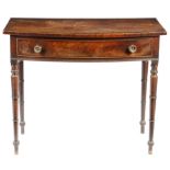 A Regency mahogany bowfront side table, the crossbanded top above a frieze drawer, on ring turned