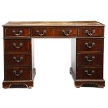 A mahogany twin pedestal desk in Chippendale style by Spillman, the top inset with a tooled