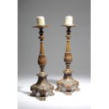 A pair of 19th century continental painted wood altar candlesticks, with fluted and leaf carved