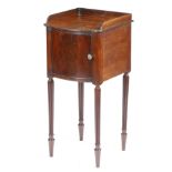 A Regency mahogany bowfront bedside cupboard in the manner of Gillows, with a three quarter