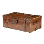 A brown leather trunk by Finnigans, brass studded, the interior with a lift-out tray, with a maker's