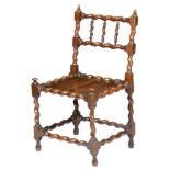 A rare Charles II yew wood 'spindle back' chair, with turned acorn finials, above a triple barley