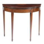 A late Victorian mahogany demi-lune card table, inlaid with stringing, the fold-over top with