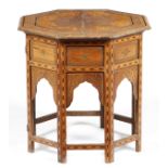 An Anglo-Indian hardwood octagonal occasional table, inlaid with brass and ebony with scrolling