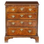 A small walnut chest in George II style, the quarter veneered top with cross and feather banding,