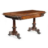 λ A William IV rosewood library table, the rectangular top with a leaf carved and nulled edge, above