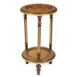 A continental stained wood and gilt composition gueridon, with two tiers, each inset with gilt