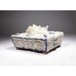An unusual mineral and quartz encrusted casket of sarcophagus shape, the lid with a central quartz