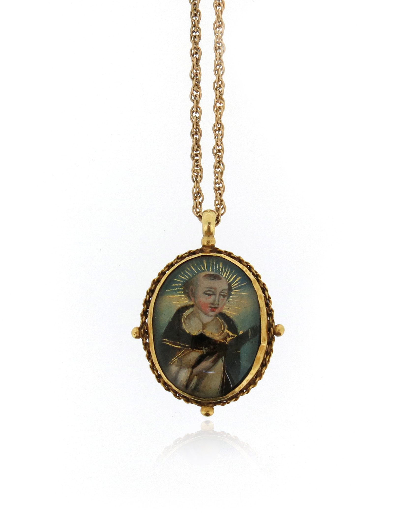 An 18th century reliquary pendant, depicting The Virgin Mary to one side and St Francis to the