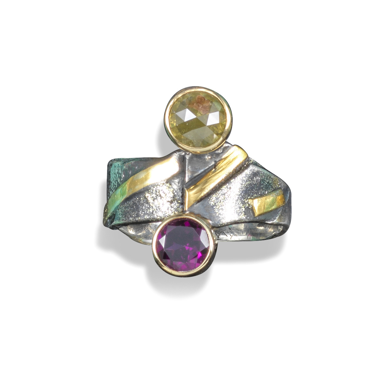 A gem-set abstract silver ring, the abstract silver and gold ring set with a circular-cut garnet and