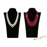 A nine-row ruby bead necklace, separated with diamond-set spacers with white gold clasp, 50cm