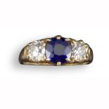 A late 19th century sapphire and diamond three-stone ring, the cushion-shaped sapphire flanked