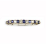 A Victorian sapphire and diamond bangle, alternately set with cushion-shaped sapphires and