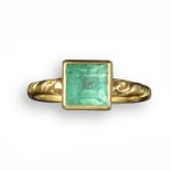 A mid 17th century emerald-set gold ring, possibly Spanish, set in a square collet with traces of