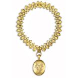 A Victorian gold collar necklace and locket, the fancy-link gold neck chain suspends an oval