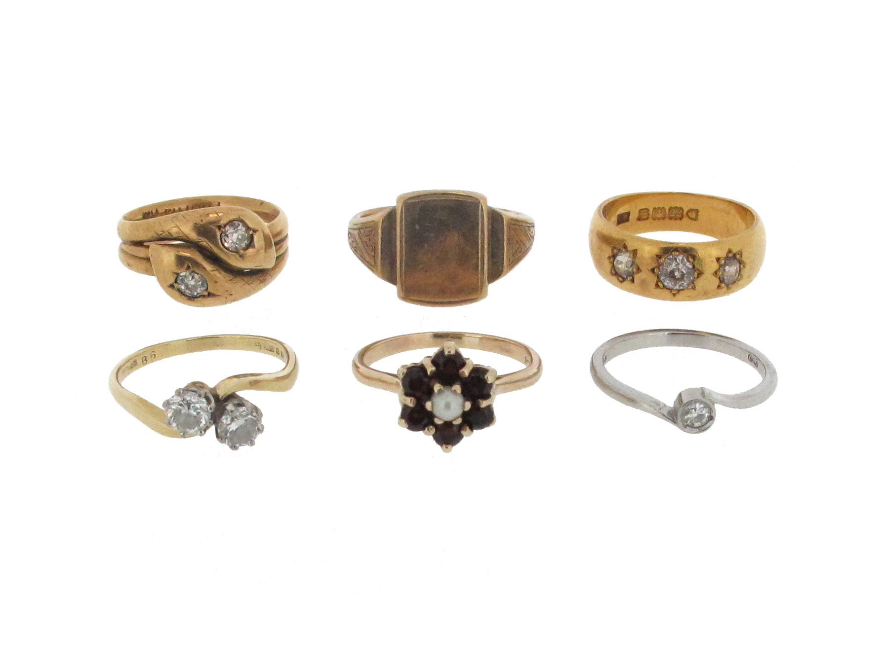 A group of six gold and gem-set rings, including a diamond two stone cross-over ring, size P, a