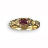 An early 19th century gold snake ring, the head set with an oval-shaped garnet and with rose-cut