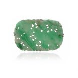 An oval-shaped jade plaque brooch, with pierced and foliate carved decoration mounted in white gold,