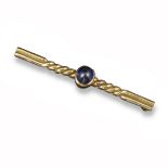 A sapphire bar brooch, the sugarloaf sapphire cabochon is set within twisted yellow gold bar brooch,