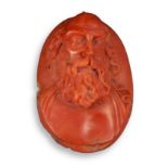 A 17th/18th century carved coral cameo, depicting the full face of a bearded man, probably a