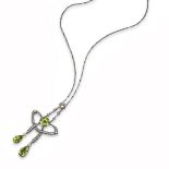 A Victorian peridot and diamond pendant, set with a cushion-shaped peridot within scrolling