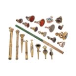A collection of gold propelling pencils and fob seals, including a ruby and diamond-set gold pencil,