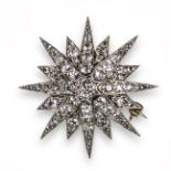 A late 19th century diamond starburst brooch pendant, set with graduated old cushion-shaped diamonds