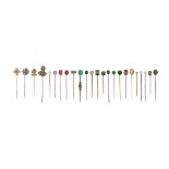 Twenty-four assorted stick pins, one set with an old circular-cut yellow diamond, a star sapphire,