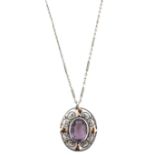 An Arts & Crafts amethyst-set silver and gold pendant, the oval-shaped amethyst within scrolling