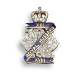 A Regimental brooch for the XIII - XVIII Royal Hussars, set with graduated circular-cut diamonds and